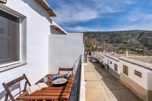 a balcony with a table and chairs on a building at Villa picena las alpujarras in Picena