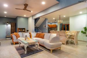a living room with a couch and a table at Ekostay Gold- Aqua Beach Villa I Partial Sea View I 1 min Walk to the Beach in Candolim