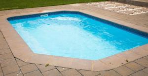 a large swimming pool with a tile floor at Marculem Guest Farm in Virginia
