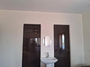 a bathroom with a sink and a mirror at Royal homes a4 in Kushālnagar