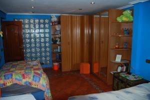 a bedroom with a bed and a book shelf at Carmen - Habitación con vistas al mar in Santander