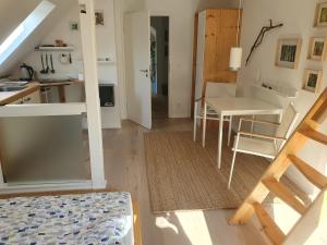 a room with a kitchen and a table and a desk at ZwischenRaum in Wuppertal