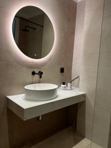 a bathroom with a sink and a mirror at Oikiaegina 1 in Aegina Town