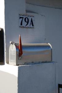 a mail box with a sign on a wall at Carmen - Habitación con vistas al mar in Santander