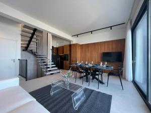 a living room with a table and a tv at Villa Grace in Polychrono