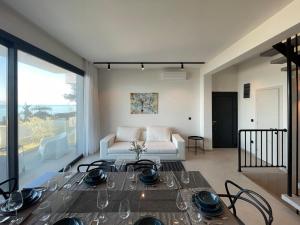 a living room with a couch and a table at Villa Grace in Polychrono +15 photos