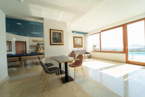 a living room with a pool table and chairs at Villa Tito Livio StarGuest in Pozzuoli
