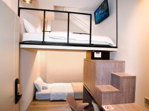 a small bedroom with a bunk bed in a room at ST Signature Jalan Besar in Singapore