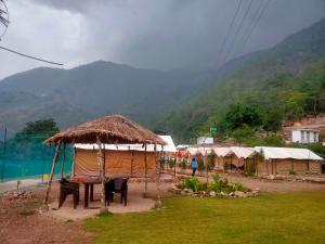 a group of tents with a view of a mountain at The Jungle Mist Resort in Rishīkesh