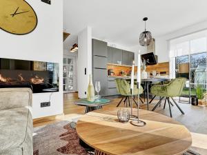 a kitchen and living room with a table and a fireplace at CBlue: Seeblick, Kamin, Wallbox, Natur in Bentwisch +57 photos