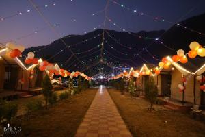 a string of lights over a street at night at The Jungle Mist Resort in Rishīkesh