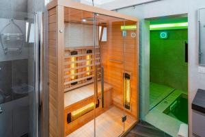 a shower with a glass door in a bathroom at LUXUITE Villa con Piscina e sauna o villa con jacuzzi e doccia emozionale in Alberobello