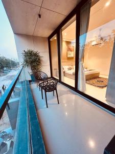 a balcony with a table and chairs on a building at The Lodgers Luxury Hotel Near Golf Course Road Gurgaon in Gurgaon