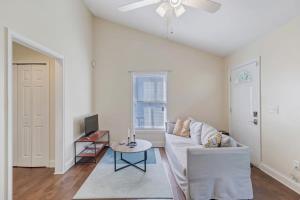 a living room with a white couch and a table at Large 1 BR carriage house in historic SPR in Jacksonville