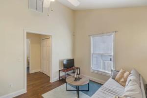 a living room with a couch and a tv at Large 1 BR carriage house in historic SPR in Jacksonville