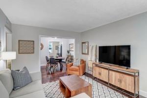 a living room with a large flat screen tv at Modern 2 BR Condo - 2 block from San Marco in Jacksonville