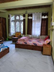a bedroom with a large bed in a room at Anna homestay in Dirang Dzong