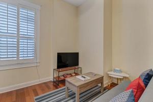 a living room with a couch and a table and a tv at LT Stay Discounts! Cozy 2 BR Apt - Pet Friendly! in Jacksonville