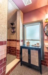 a bathroom with a shower with a glass door at Studio loft w pool spa & gardens near downtown in Jacksonville