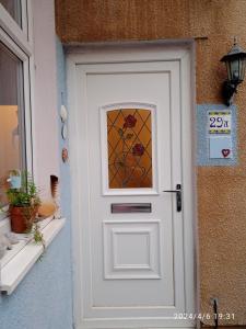 a white door with a stained glass window on it at Captivating 2-Bed Hideaway Apartment in Gloucester in Gloucester