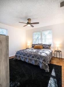 a bedroom with a bed and a ceiling fan at Charming Riverside Retreat 1 1 - Near 5 Points #3 in Jacksonville
