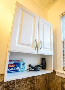 a white cabinet with a window in a kitchen at Charming Riverside Retreat 1 1 - Near 5 Points #3 in Jacksonville