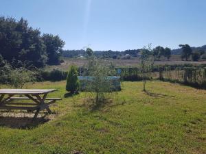 a picnic table in the middle of a field at VibesMuxía - Casa Rural Escola in Muxia