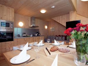 a wooden table with a vase of flowers on it at Apartment in Ramsau im Zillertal with sauna in Ramsau im Zillertal