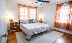 a bedroom with a bed and a ceiling fan at Charming Riverside Retreat 1 1 - Near 5 Points #4 in Jacksonville