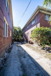 an empty alley next to a brick building at Charming Riverside Retreat 1 1 - Near 5 Points #2 in Jacksonville