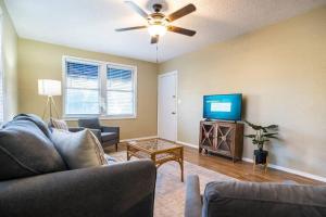 a living room with a couch and a flat screen tv at Charming Riverside Retreat 1 1 - Near 5 Points #2 in Jacksonville