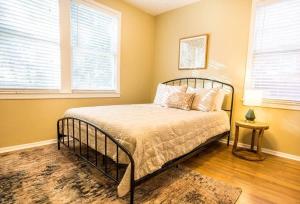 a bedroom with a bed and two windows at Charming Riverside Retreat 1 1 - Near 5 Points #2 in Jacksonville