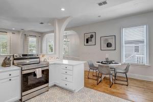 a white kitchen with a table and chairs and a table and a tablektop at Charming 1BR Apt in Historic Springfield in Jacksonville