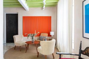 a living room with a table and chairs at Magno Apartments Almirante Hoyos House in Seville