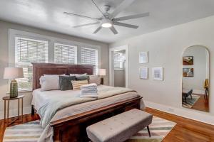 a bedroom with a large bed with a ceiling fan at Cozy Retreat - Walkable to Bars & Restaurants in Jacksonville