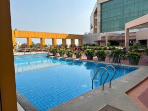 a large swimming pool in the middle of a building at Hotel the Plaza in Hyderabad