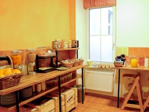 a kitchen with a counter with food on it at Sleepy Lion Hostel & Apartments Leipzig in Leipzig