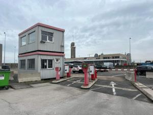 a small building in a parking lot with cars at Ostend Centre Bayview Apartment + Free Parking in Ostend
