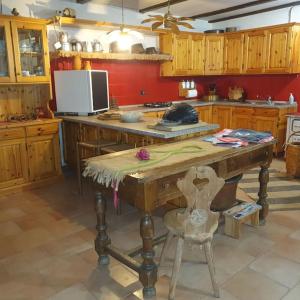 a kitchen with a wooden table with a chair at Baita - Chalet tra Pinzolo e Madonna di Campiglio in Madonna di Campiglio