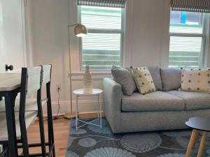 a living room with a couch and a table at Chic & Fresh 1BR Apt - 2 blocks from 5 Pts in Jacksonville