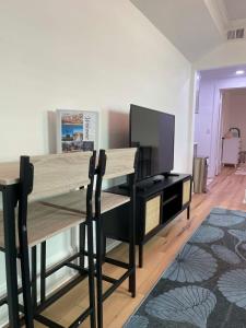 a dining room with a table and a tv at Chic & Fresh 1BR Apt - 2 blocks from 5 Pts in Jacksonville