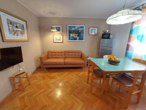 a living room with a couch and a table at Apartman Solis in Cres