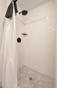 a shower with a shower curtain in a bathroom at Fun Cozy Apts - 1 25 Mile Walk to TIAA Bnk Fld in Jacksonville