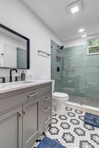 a bathroom with a sink and a toilet and a shower at Contemporary Apartment - 5 Min To TIAA Bank Field! in Jacksonville