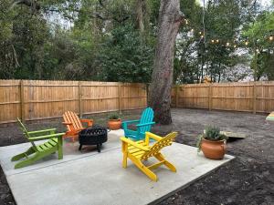 un grupo de sillas coloridas sentadas en un patio en Contemporary Apartment - 5 Min To TIAA Bank Field! en Jacksonville