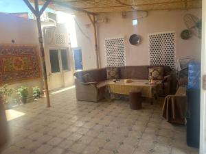 a living room with a couch and a table at Guest house Lovely Guest in Bukhara +24 photos