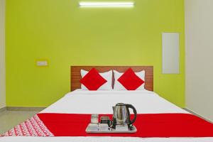 a bedroom with a bed with a blender on it at Hotel Elite Stay Near Habsiguda Metro Station in Hyderabad