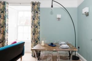 a dining room with a table and a window at St Richard's Apartment in Chichester