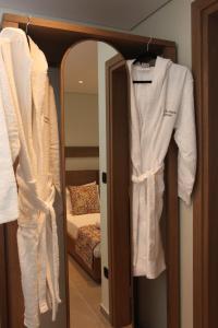 a room with a bed and a robe hanging on a closet at IPELHOME-Avissinias Boutique Apartments in Athens