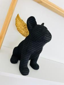 a black teddy bear with angel wings on a shelf at Villa Louméa - Le Loft avec jacuzzi in Friesenheim